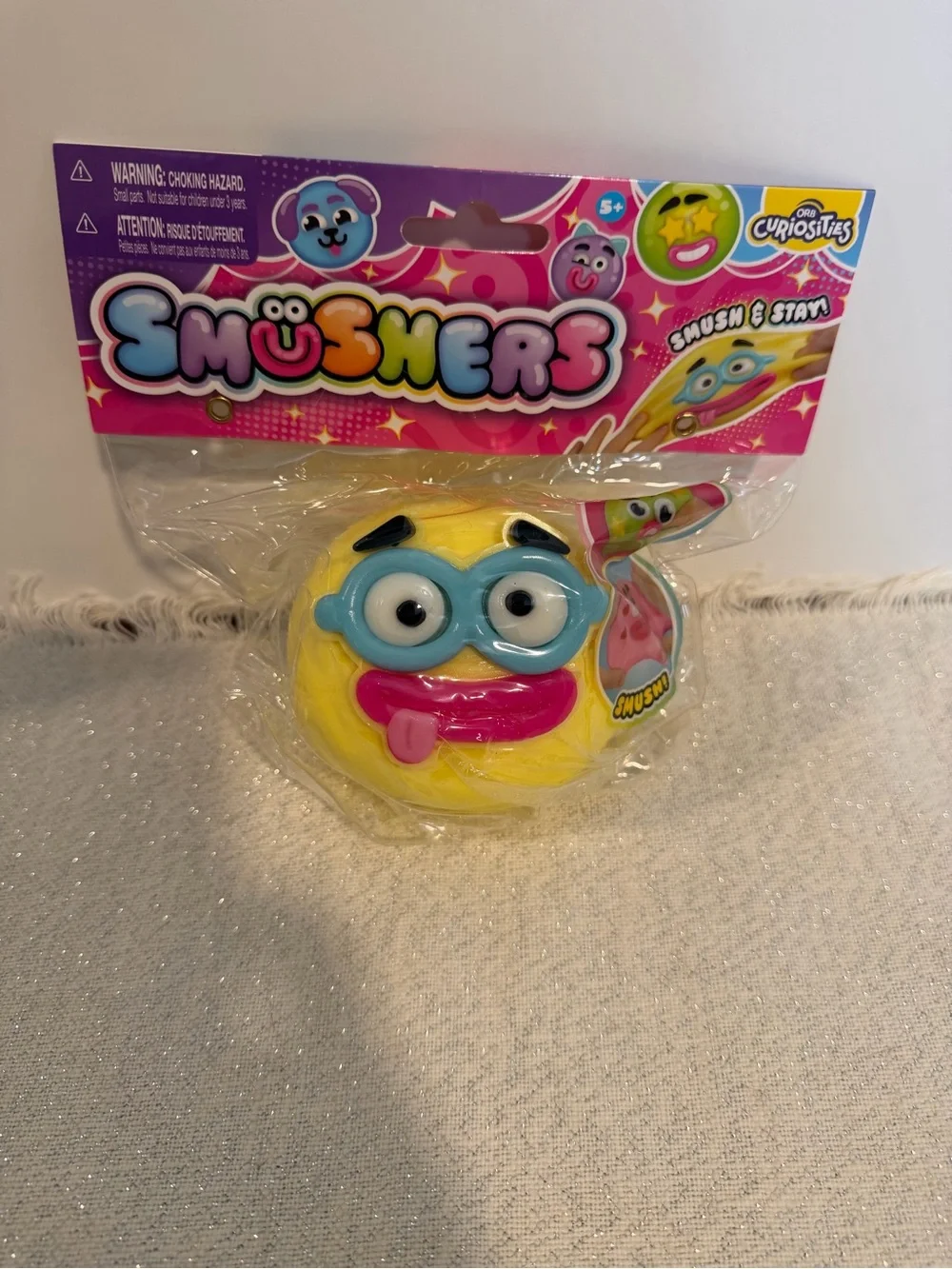 Orb Smushers Yellow Emoji Squishy Toy with Blue Glasses and Pink Tongue